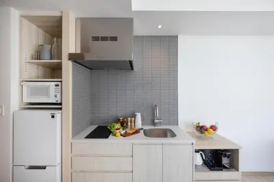 a kitchen with a sink and a white refrigerator at Hyatt House Tokyo Shibuya in Tokyo