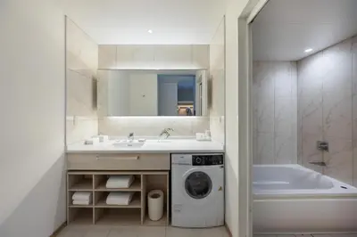 a bathroom with a sink and a washing machine at Hyatt House Tokyo Shibuya in Tokyo