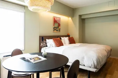 a bedroom with a bed and a table and a dining room at Section L Ueno-Hirokoji in Tokyo