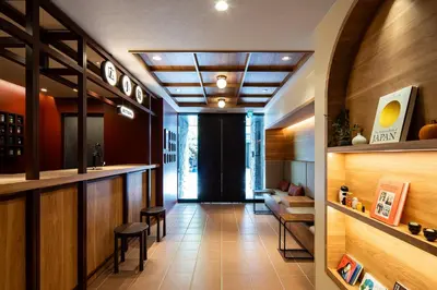 a room with a bar and a table and chairs at Section L Ueno-Hirokoji in Tokyo