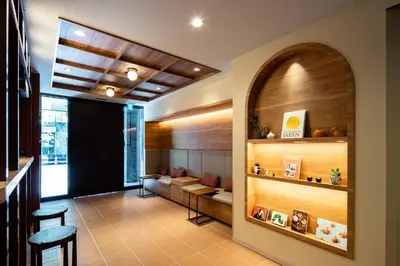 a lobby with a waiting room with a table and chairs at Section L Ueno-Hirokoji in Tokyo