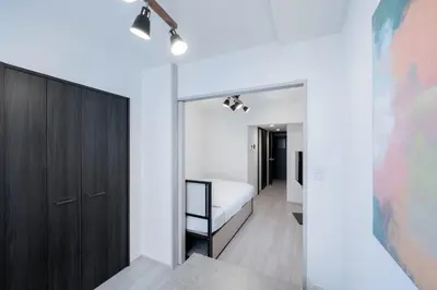 a bedroom with a bed and a closet at \u30a6\u30a7\u30eb\u30b9\u30af\u30a8\u30a2\u30a4\u30ba\u30e0\u5927\u585a in Tokyo