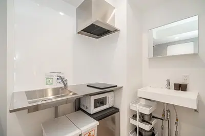 a white kitchen with a sink and a microwave at ZAITO Tokyo Skytree Yokokawa III \u9326\u7cf8\u753a\u99c5\u304b\u3089\u5f92\u6b69\uff19\u5206 in Tokyo
