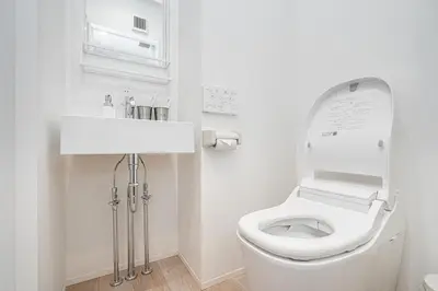 a white bathroom with a toilet and a sink at ZAITO Tokyo Skytree Yokokawa III \u9326\u7cf8\u753a\u99c5\u304b\u3089\u5f92\u6b69\uff19\u5206 in Tokyo