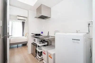 a small kitchen with a sink and a refrigerator at ZAITO Tokyo Skytree Yokokawa III \u9326\u7cf8\u753a\u99c5\u304b\u3089\u5f92\u6b69\uff19\u5206 in Tokyo