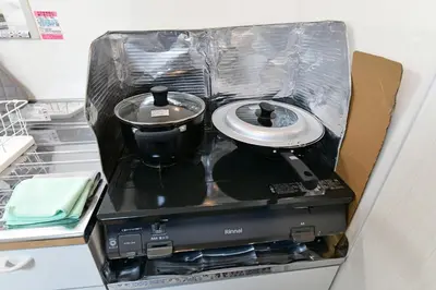 a stove in a drawer in a refrigerator at JH Yellow Guest House in Tokyo
