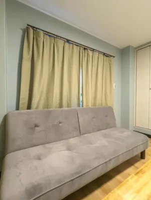 a large couch in a room with a window at \u6bbf\u5802 in Tokyo