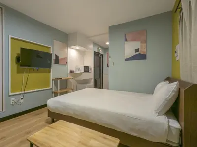 a bedroom with a large bed and a tv at \u6bbf\u5802 in Tokyo