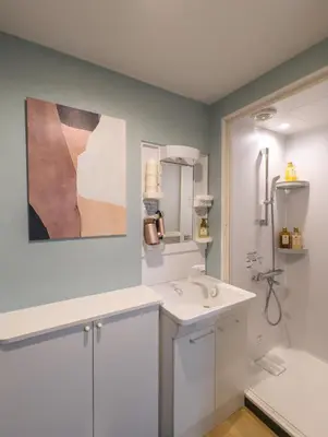 a bathroom with a white sink and a shower at \u6bbf\u5802 in Tokyo