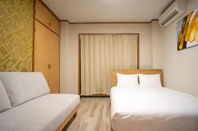 a small room with two beds and a couch at \u6bbf\u5802 in Tokyo