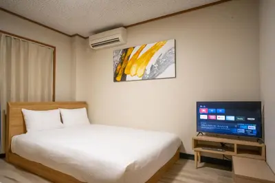 a bedroom with a bed and a flat screen tv at \u6bbf\u5802 in Tokyo