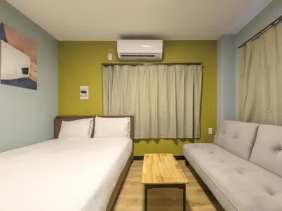 a bedroom with a bed and a couch and a table at \u6bbf\u5802 in Tokyo