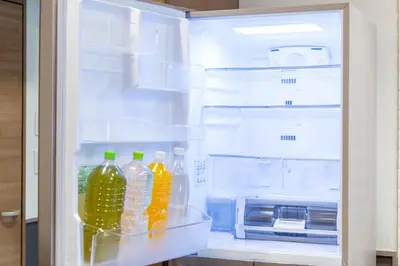 an open refrigerator with bottles of water and a microwave at HOTEL PASELA LIVING - Vacation STAY 84860v in Tokyo