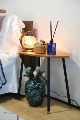 a table with a vase and a lamp on it at Housegreen in Tokyo