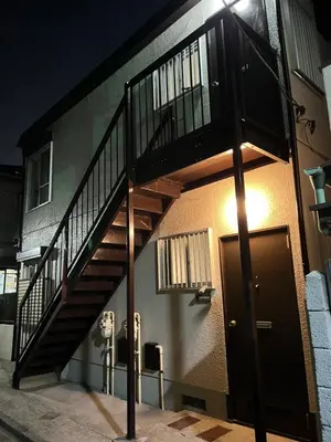 a wooden staircase on the side of a building at Housegreen in Tokyo
