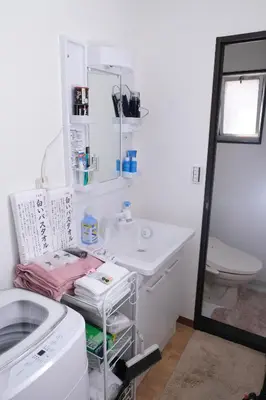 a white bathroom with a sink and a toilet at Housegreen in Tokyo