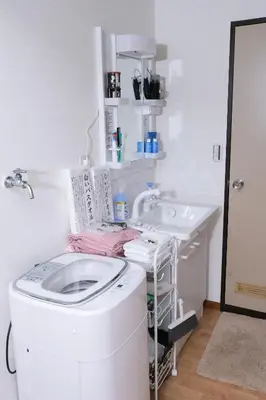 a washing machine in a bathroom with a sink at Housegreen in Tokyo