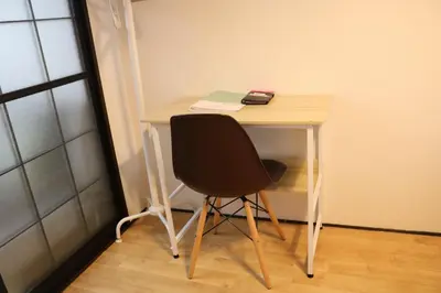 a desk with a chair and a phone on it at Housegreen in Tokyo