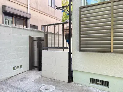 a gate on the side of a building at Housegreen in Tokyo
