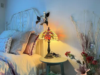 a bedroom with a bed with a lamp on a table at Housegreen in Tokyo