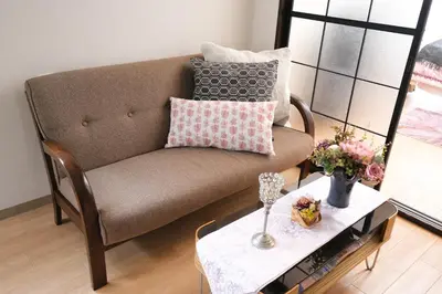 a living room with a couch and a table at Housegreen in Tokyo
