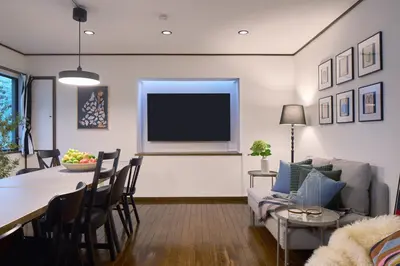a living room with a television and a table and chairs at PDO inn Sangenjaya Art residence in Tokyo