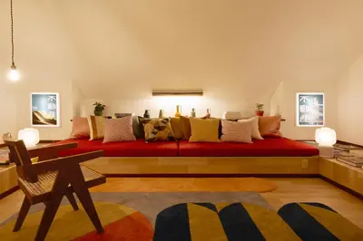 a bedroom with a large red bed with many pillows at PDO inn Sangenjaya Art residence in Tokyo
