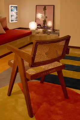 a wooden chair in a living room with a table at PDO inn Sangenjaya Art residence in Tokyo