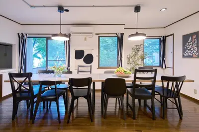 a kitchen and dining room with a table and chairs at PDO inn Sangenjaya Art residence in Tokyo