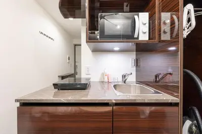a kitchen with a sink and a microwave at HJ PLACE SHIBUYA in Tokyo