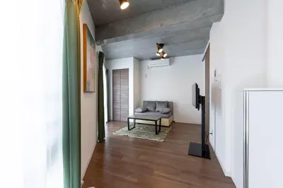 a living room with a couch in a room at JASPER Waseda in Tokyo