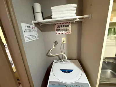 a small bathroom with a toilet and towels at LARK OKUBO Free wifi in Tokyo