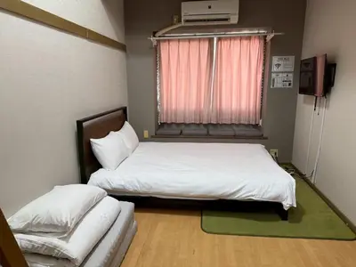 a bedroom with a white bed and a window at LARK OKUBO Free wifi in Tokyo
