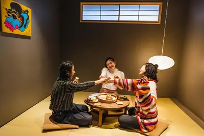 a group of three people sitting around a table at YANAKA SOW - Cultural Boutique Hotel in Historical area Yanaka - Near Ueno Akiba in Tokyo