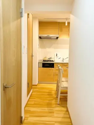 a hallway leading to a kitchen with wooden floors at Tokyo Louis House in Ueno area close to JR Yamanote Line & Metro Ginza Line walk to Ueno Park and Ameyoko in Tokyo