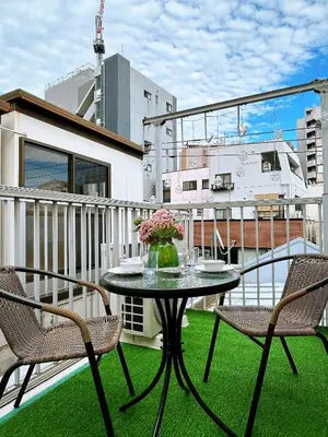 a patio with a table and chairs on a balcony at Tokyo Louis House in Ueno area close to JR Yamanote Line & Metro Ginza Line walk to Ueno Park and Ameyoko in Tokyo