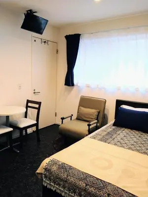 a room with two beds and a table and chairs at Tokyo stay Hut SARI - Vacation STAY 84619v in Tokyo