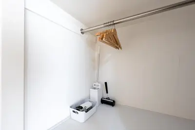 a room with a white wall with a light fixture at Beige in Tokyo