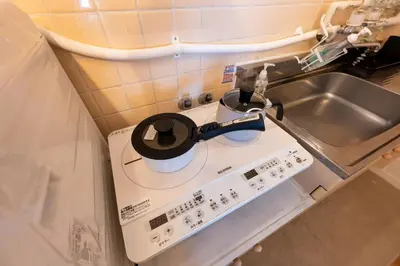 a tea pot on top of a stove in a kitchen at Beige in Tokyo