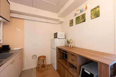 a kitchen with a wooden counter and a refrigerator at Beige in Tokyo