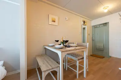 a dining room with a table with two chairs and wine glasses at Beige in Tokyo