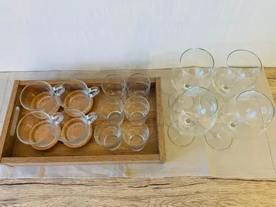 four empty wine glasses sitting on a wooden tray at Beige in Tokyo