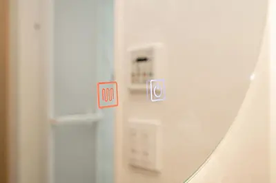 a mirror in a room with a door with a sign at ZAITO Tokyo Narihira Hotel\u3000\u62bc\u4e0a\u99c5\u304b\u3089\u5f92\u6b69\u516b\u5206\u30db\u30c6\u30eb in Tokyo