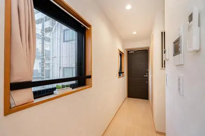 a hallway with a large window and a door at ZAITO Tokyo Narihira Hotel\u3000\u62bc\u4e0a\u99c5\u304b\u3089\u5f92\u6b69\u516b\u5206\u30db\u30c6\u30eb in Tokyo