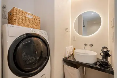 a bathroom with a washing machine and a sink at ZAITO Tokyo Narihira Hotel\u3000\u62bc\u4e0a\u99c5\u304b\u3089\u5f92\u6b69\u516b\u5206\u30db\u30c6\u30eb in Tokyo