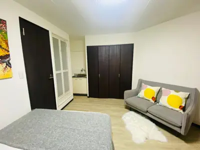 a living room with a couch and a bed at Yama house AD0234 in Tokyo