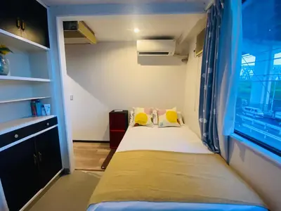 a small bedroom with a bed and a window at Yama house AD0234 in Tokyo