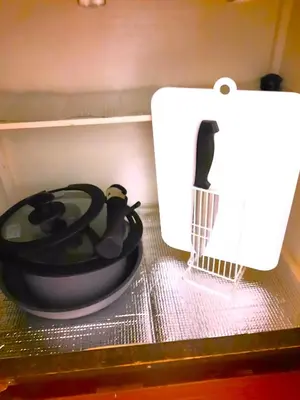 a hair dryer sitting on a counter next to a paper towel at Shinjuku Harusame Apartment -Twin room- in Tokyo
