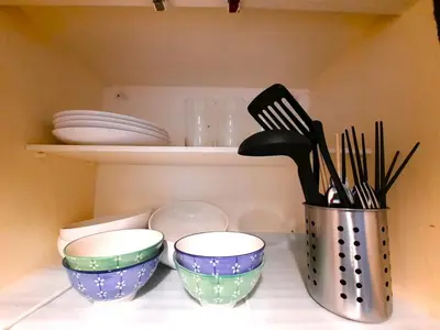 a kitchen counter with three bowls and utensils at Shinjuku Harusame Apartment -Twin room- in Tokyo