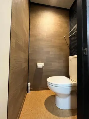 a bathroom with a white toilet in a room at Lucky Hotel in Tokyo